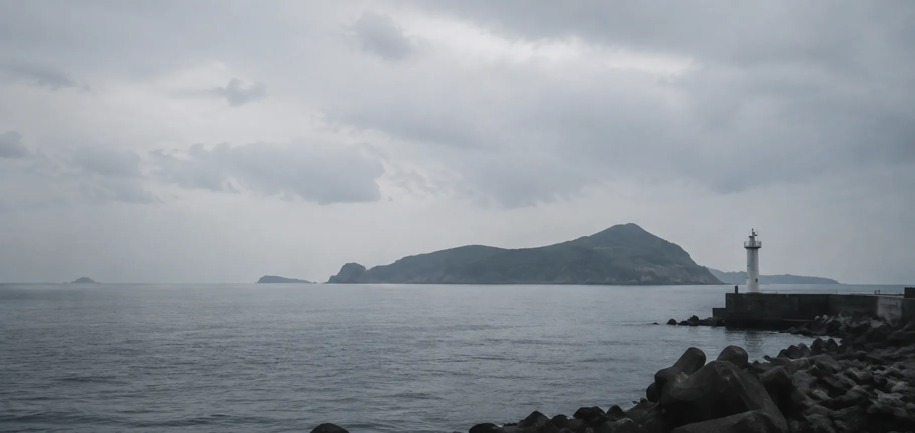 陰天海港望向遠方離島與燈塔